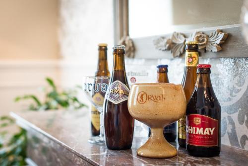 a group of bottles of beer sitting on a counter at B&B Avenue Deschanel in Brussels