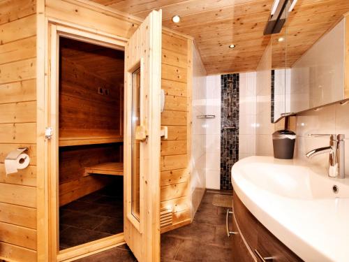 a bathroom with a toilet and a sink at Atmospheric chalet with sauna and jacuzzi in Septon