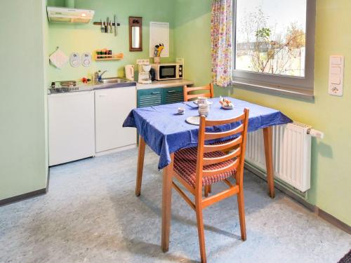 a kitchen with a table with a blue table cloth at Wohnung nahe Ostsee Graal Müritz Strand in Rövershagen