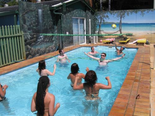 a group of people in a swimming pool at Aussitel Backpackers in Coffs Harbour
