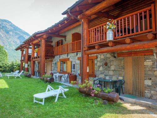 une maison en bois avec un banc devant elle dans l'établissement Belvilla by OYO GrBe Quadri, à Antey-Saint-André