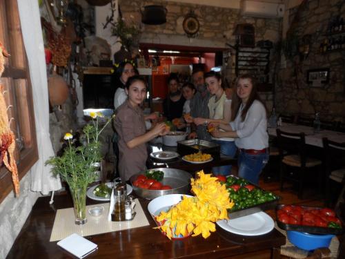 a group of people standing around a table with food at Sivas Apartments-Studios,Sigelakis with very nice view in Sívas