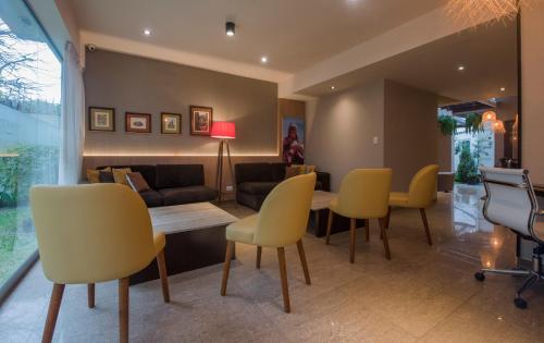 a living room with a table and yellow chairs at El Tambo 1 in Lima