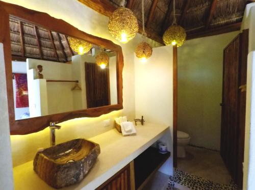 a bathroom with a wooden sink and a mirror at Tulum Nueve in Tulum