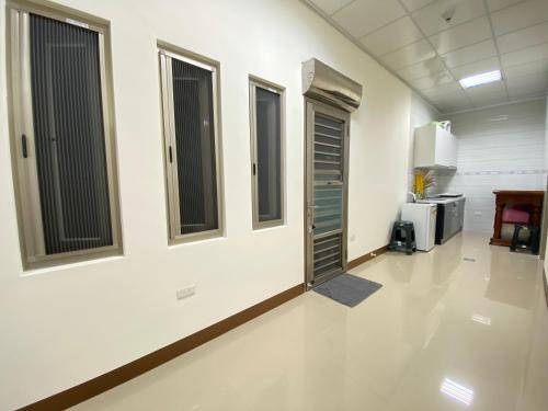 an empty hallway of a hospital with windows and a room at Chill島嶼 in Xiaoliuqiu
