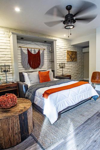 a bedroom with a large bed and a wooden table at Hotel California - A Town & Desert Boutique Hotel in Palm Springs