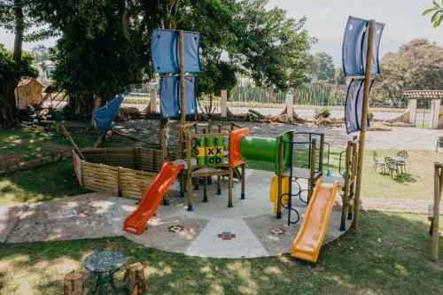 a park with a playground with slides at Hotel El Castillo Chinauta in Chinauta