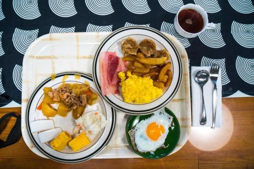 two plates of food on a tray with breakfast foods at Kogakuro in Myoko