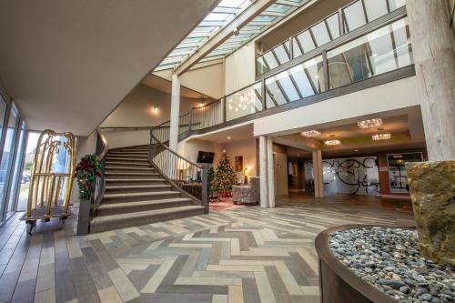 a lobby with a staircase in a building at Travelodge by Wyndham Parksville in Parksville
