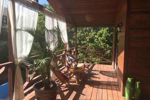 a boy sitting on the porch of a house at blue angel 3 in Playa del Carmen