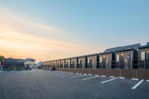 a row of train cars parked in a parking lot at HOTEL R9 The Yard Isesaki in Isesaki