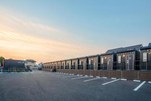 a row of train cars parked in a parking lot at HOTEL R9 The Yard Isesaki in Isesaki