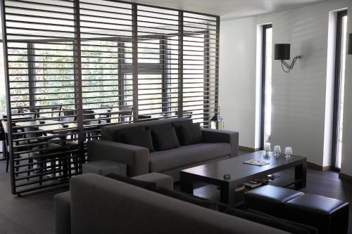 a living room with a couch and a table at Hotel Domus in Boom
