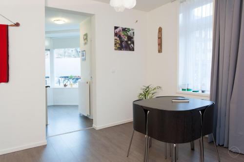 a dining room with a black table and chairs at Bos en Lommer Hotel - Erasmus Park area in Amsterdam