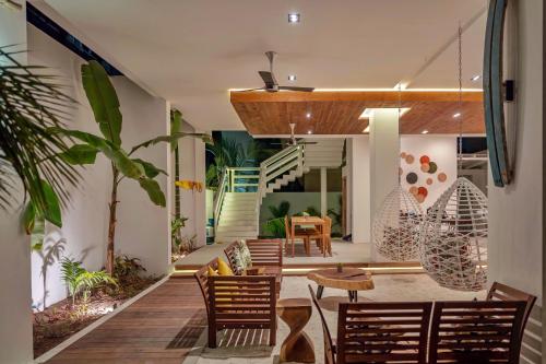 a patio with chairs and a table and stairs at Shaviyani Retreat in Ukulhas