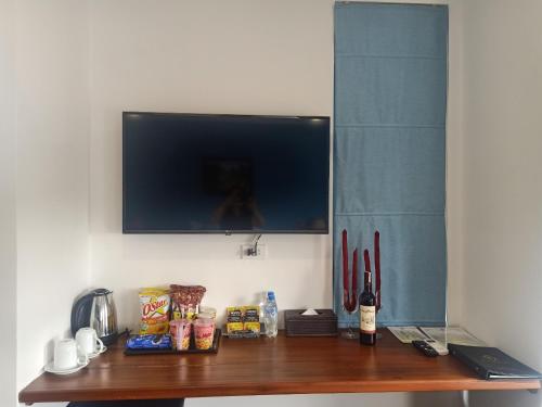 a wooden table with a television on a wall at Royal Khanh Hotel in Tuy Hoa