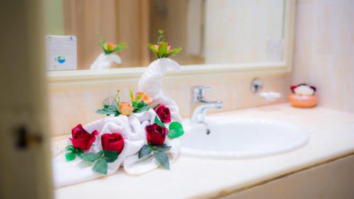 a bathroom counter with a sink with roses on it at Amir Palace in Monastir