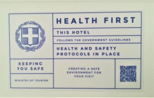 a sign that readshealth first this hotel follows the government guidelineshealth and safety protocols at Scorpios Hotel & Suites in Samos