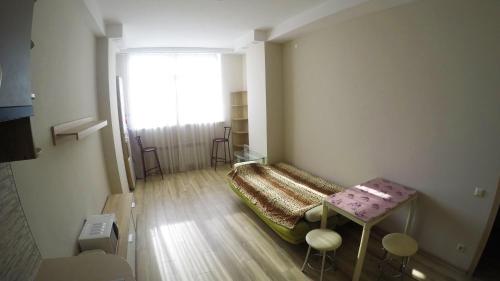a small room with a bed and a table at Просторная квартира в Одессе in Odesa
