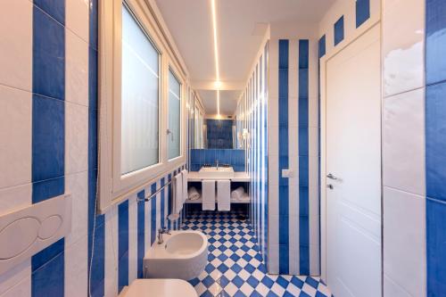a blue and white bathroom with a sink and a toilet at Luxury&Romantic Apartment with Balcony in Sorrento in Sorrento