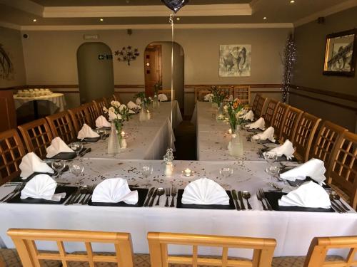 a long table in a room with chairs at The George Hotel in Montrose