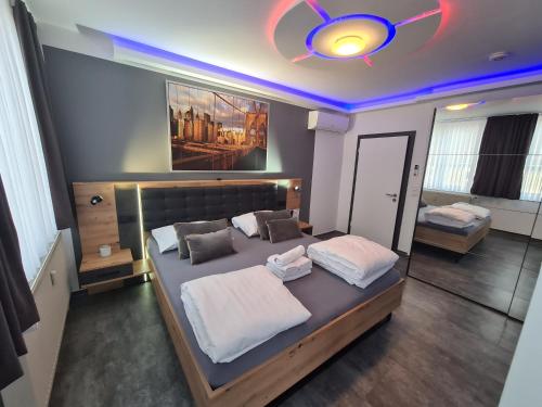 a bedroom with two beds and a ceiling at Pension Zwei A in Leverkusen
