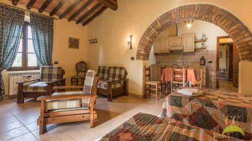 a large room with a kitchen and a living room at Colle Cavalieri - Country House in Gavorrano