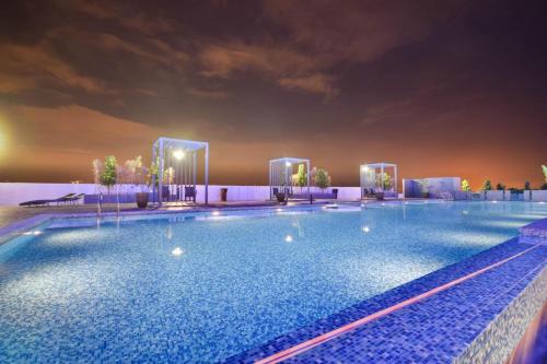 a large swimming pool at a hotel at night at Landmark Residence 1 SOHO 2pax by A's Homestay 8 in Kajang