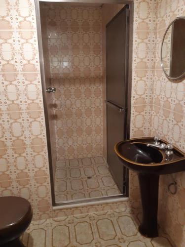 a bathroom with a sink and a shower at Hotel Paraguai (Adult Only) in Rio de Janeiro