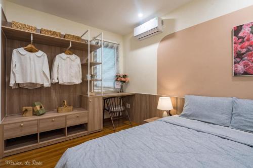 a bedroom with a bed and a desk and a window at Maison de Rose in Quy Nhon