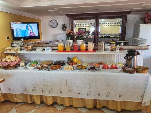 a table with a bunch of food on it at Hotel Sta Mônica Marília in Marília