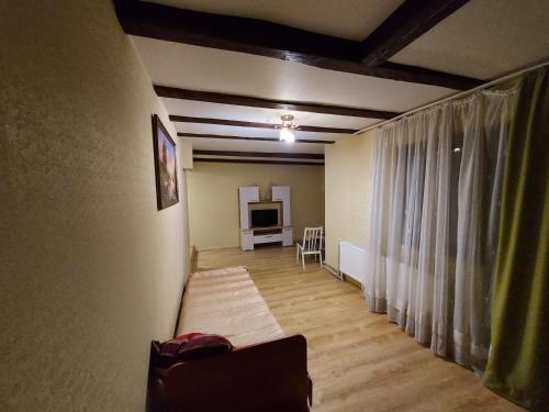 a living room with a couch and a television at Приватна Садиба "КУВІК" in Yasinya