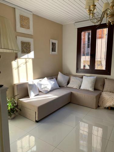 a living room with a couch and a window at Katerina 1 Bedroom House in Zakynthos Town