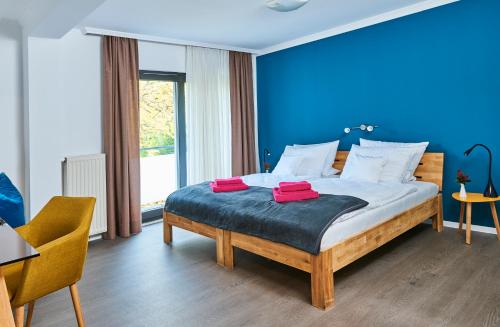 um quarto com uma cama grande e uma parede azul em SCHLAFGUT! HOTEL-WILL.ICH Garni em Willich