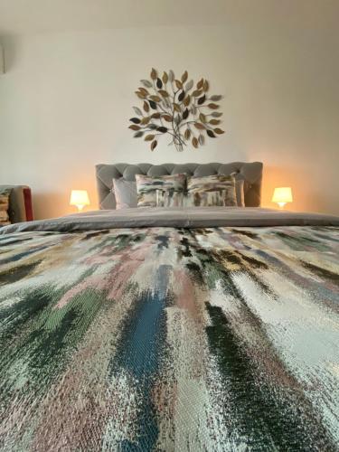 a bedroom with a bed with a table and a couch at Eden Luxury in Brăila