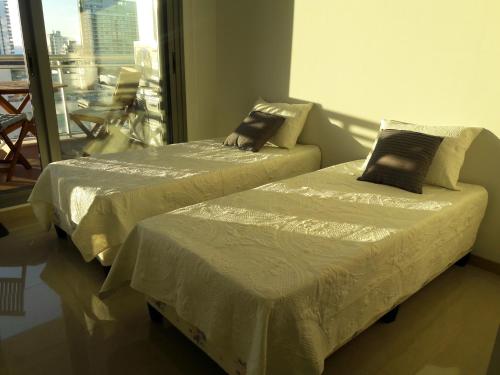 two beds sitting next to each other in a room at Departamento en Punta del Este in Punta del Este