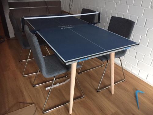 a ping pong table with four chairs around it at Roter Bär im Quellenweg in Sankt Andreasberg