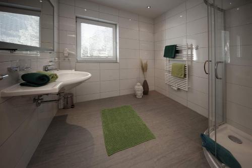 a white bathroom with a sink and a shower at Apart Mount Everest in Sölden