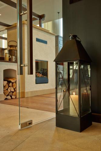 a glass case with a candle inside of a room at H4 Hotel München Messe in Munich