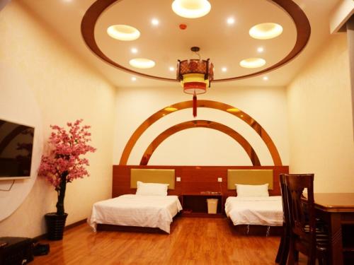 um quarto com 2 camas e um tecto arqueado em Shell Jinan Zhangqiu District Diao Town Center Street Hotel em Jinan