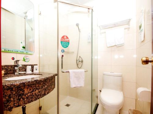 a bathroom with a shower and a toilet and a sink at GreenTree Inn Tianjin Huanghe Ave Guangkai Metro Station Express Hotel in Tianjin