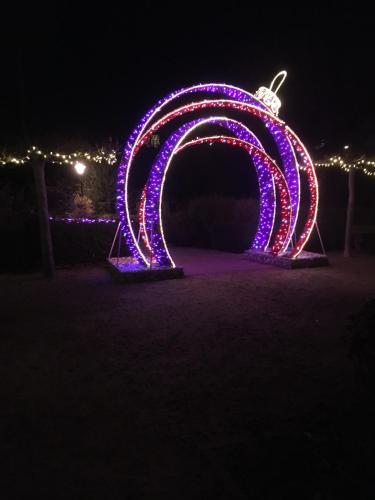 a large arch covered in purple lights at night at Charmant appartement met frontaal zeezicht in Middelkerke