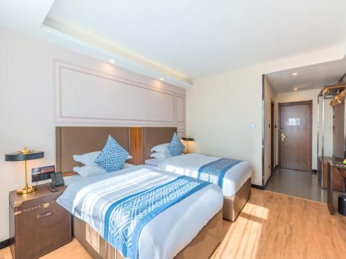 Postel nebo postele na pokoji v ubytování Gme Fuyang Guangming South Road Hotel