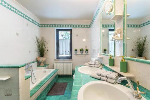 a bathroom with two sinks and a tub at Villa EMI in Zgornje Škofije