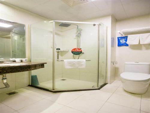 a bathroom with a shower with a toilet and a sink at Greentree Inn Anhui Hefei South High-speed Rail Station Fanhua Avenue Haiheng Express Hotel in Hefei