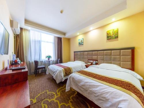Ένα ή περισσότερα κρεβάτια σε δωμάτιο στο GreenTree Inn GanSu LanZhou JingNing Road Express Hotel