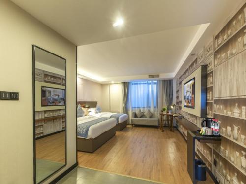 Postel nebo postele na pokoji v ubytování Gme Fuyang Guangming South Road Hotel