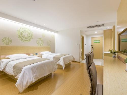 a bedroom with two beds and a room with at GreenTree Inn Xuzhou Ou Shasha Building Materials City Express Hotel in Xuzhou