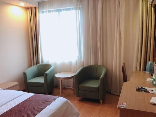 Ένα ή περισσότερα κρεβάτια σε δωμάτιο στο GreenTree Inn Jiangsu Suzhou Kunshan Qiandeng Ancient Town Hotel