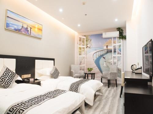 a hotel room with two beds and a desk at Shell Wuxi Huishan DistrictWanda Plaza Yanqiao Subway Station Hotel in Wuxi